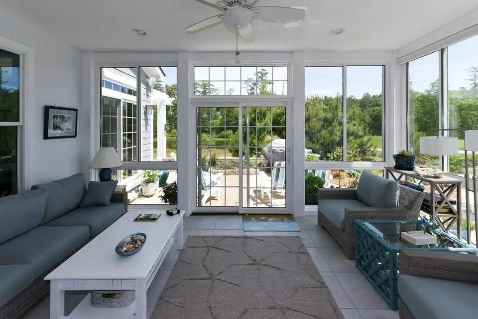 Luxury custom sunrooms showcasing vaulted tongue-and-groove ceilings, motorized skylights, and architectural millwork that seamlessly matches existing Troutman residential styles.