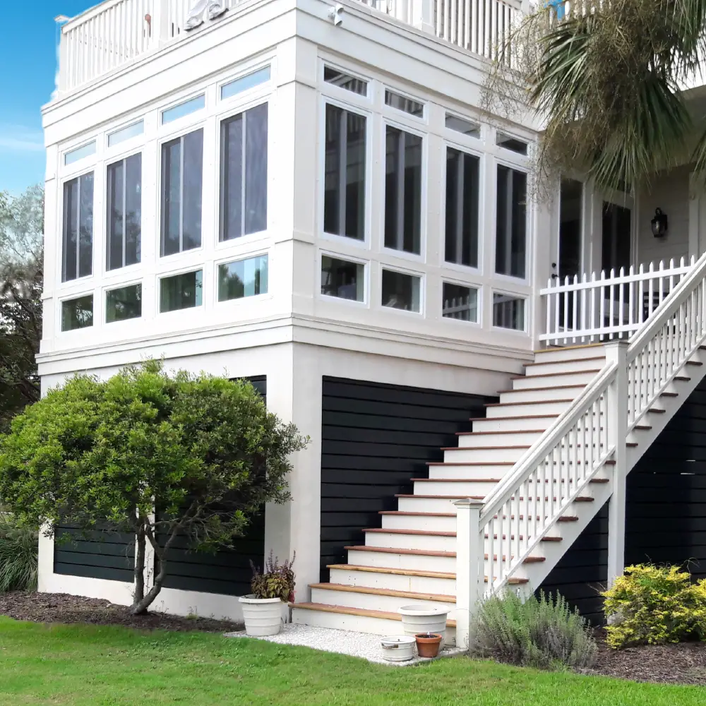 Luxury patio enclosure installation featuring motorized privacy screens, integrated HVAC vents, and a seamless transition to the existing roofline for a Troutman residential estate.