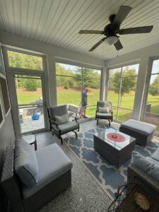 Professional performing routine maintenance on a sunroom in the Carolinas