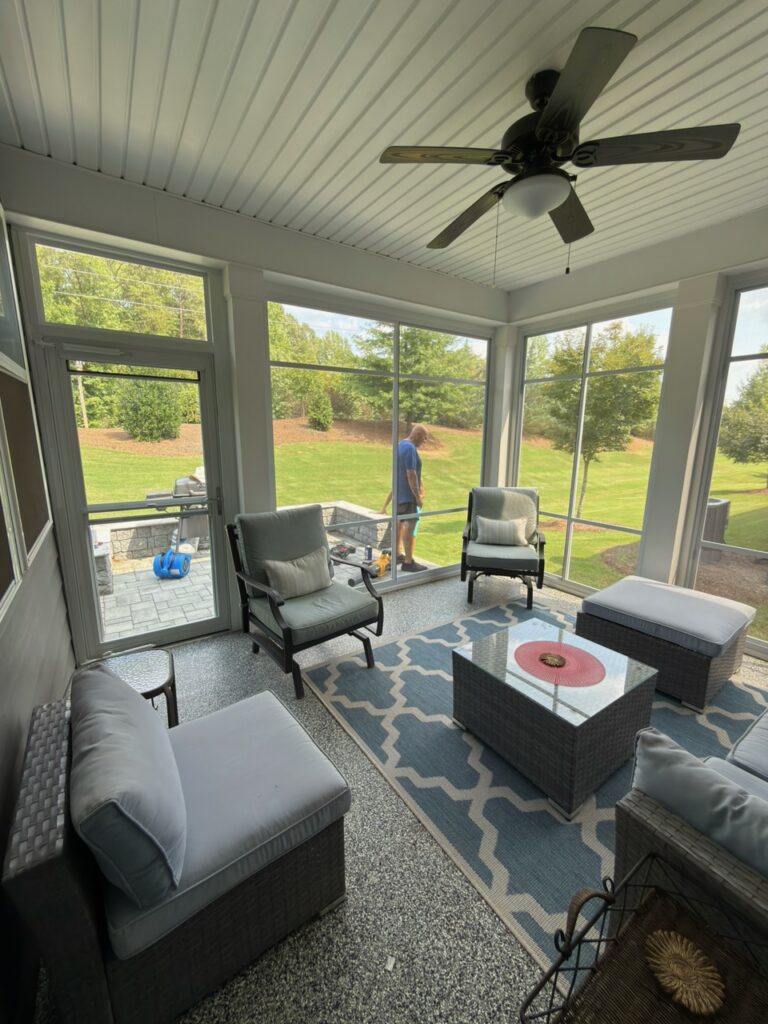 Professional performing routine maintenance on a sunroom in the Carolinas