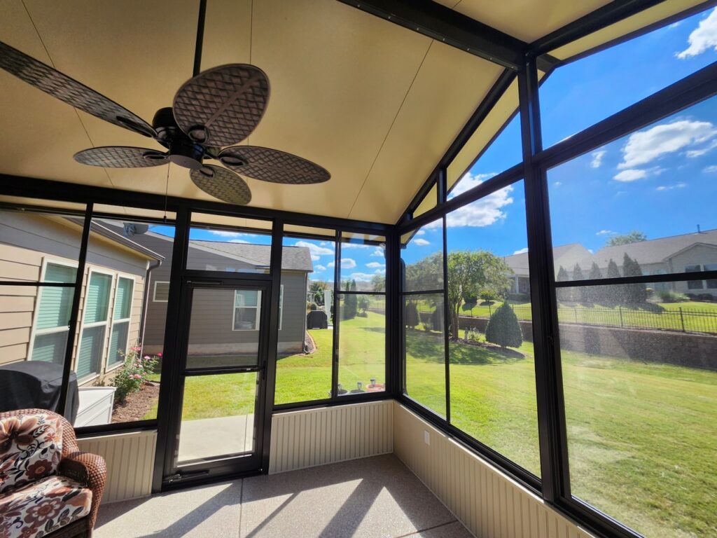 Vinyl porch panels enclosing a covered porch with views of the backyard
